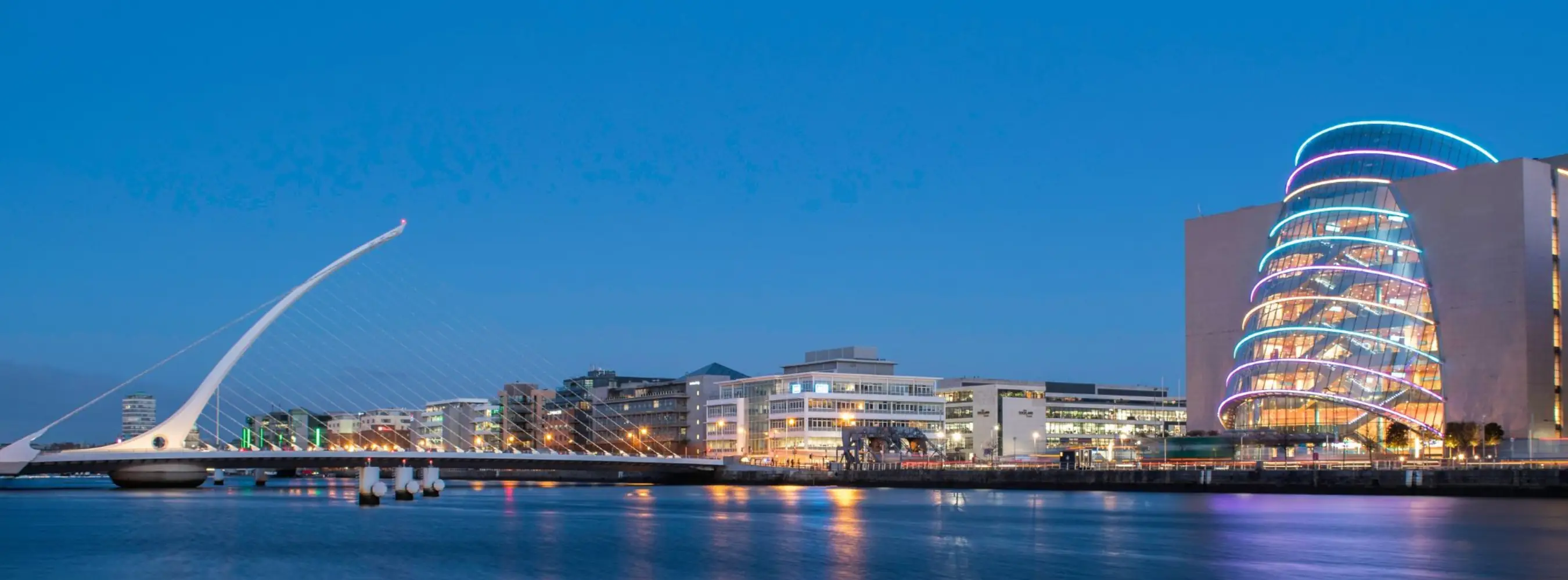 Samuel Beckett Bridge and the Convention Centre Dublin lit up at dusk