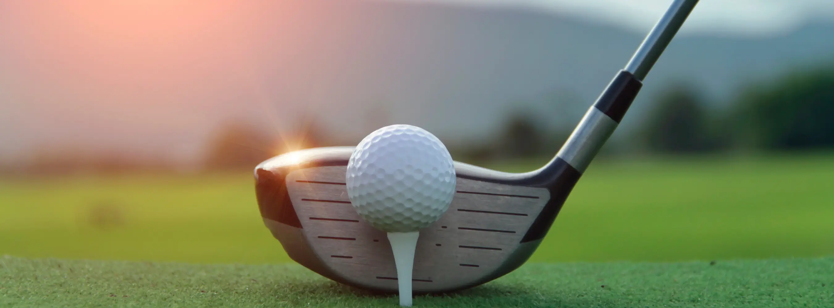 Golf club and ball on a tee ready to drive off